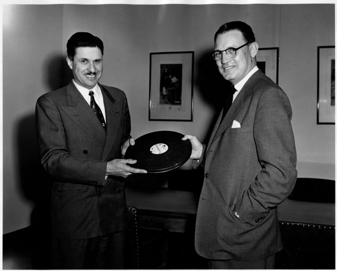 Figure 9. Chaffee (left) receives a copy of -Idaho on the March- from First National Bank